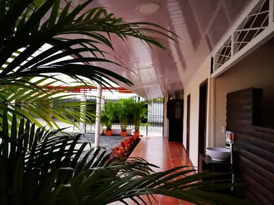 a hallway of a building with plants in it at Hotel Amaranto in San Ramón