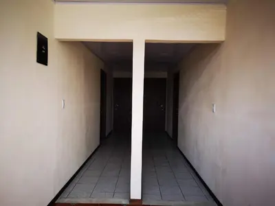 an empty hallway of a building with two doors at Hotel Amaranto in San Ramón
