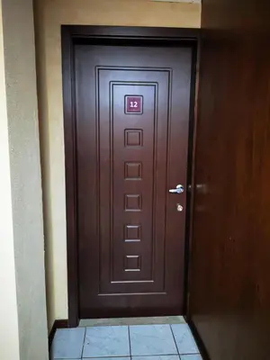 a brown door with a sign on it in a hallway at Hotel Amaranto in San Ramón