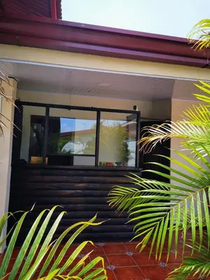 a front door of a house with a window at Hotel Amaranto in San Ramón