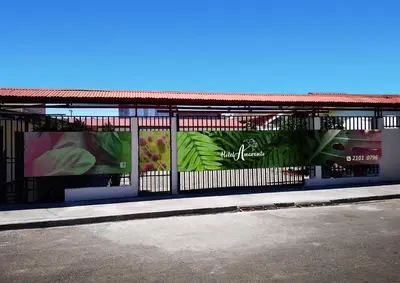 a fence with advertisements on the side of a building at Hotel Amaranto in San Ramón