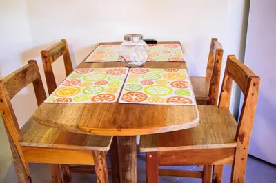a wooden table with a vase on top of it at Casa Nelly Apartamentos in Sámara