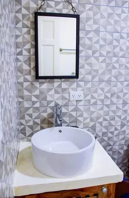a bathroom with a white sink and a mirror at Casa Nelly Apartamentos in Sámara