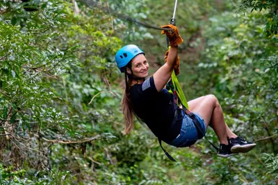 a woman on a zip line in the jungle at Rinconcito Lodge in Liberia