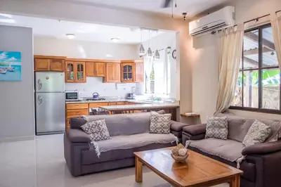 a living room with two couches and a table at Zula Inn Aparthotel in Santa Teresa Beach