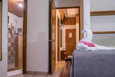 a room with a bed with a stuffed animal on it at Zula Inn Aparthotel in Santa Teresa Beach