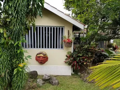 a house with a mask on the side of it at Casa Sophia 3 listings Apartment 1 or Apartment 2 separately or Apt 1 and 2 together all with FO internet in Guápiles