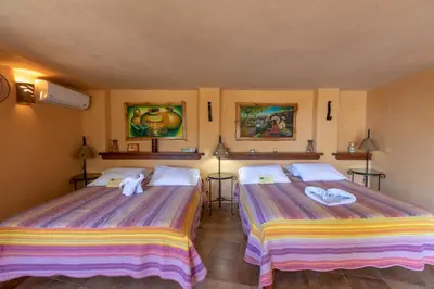 a room with two beds with towels on them at Villa Mango B&B in Nosara