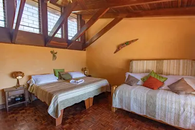 a bedroom with two beds in a room at Villa Mango B&B in Nosara
