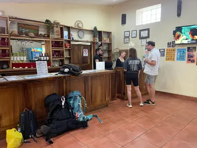 a group of people standing at a bar in a store at Costa Rica Guesthouse in San José