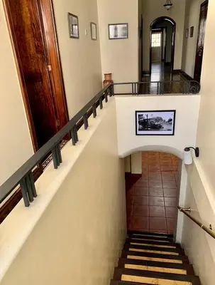 a staircase in a building with a stair case at Costa Rica Guesthouse in San José