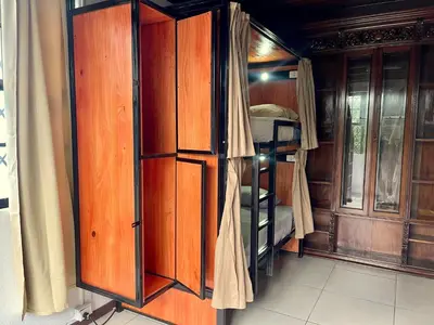a room with wooden cabinets and a bunk bed at Costa Rica Guesthouse in San José