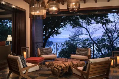 a room with a table and chairs and a large window at Four Seasons Resort Peninsula Papagayo, Costa Rica in Papagayo, Guanacaste