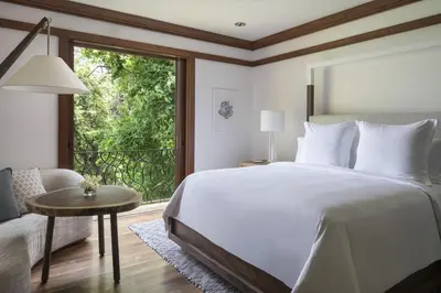 a bedroom with a large bed and a large window at Four Seasons Resort Peninsula Papagayo, Costa Rica in Papagayo, Guanacaste