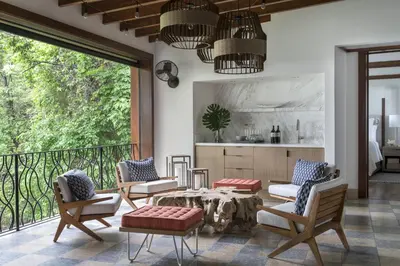 a living room with a table and chairs on a balcony at Four Seasons Resort Peninsula Papagayo, Costa Rica in Papagayo, Guanacaste