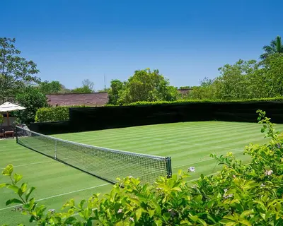 a tennis court with a net on top of it at Four Seasons Resort Peninsula Papagayo, Costa Rica in Papagayo, Guanacaste