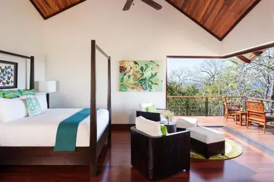 a bedroom with a bed and a balcony at Four Seasons Resort Peninsula Papagayo, Costa Rica in Papagayo, Guanacaste