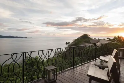 a balcony with a view of the water at Four Seasons Resort Peninsula Papagayo, Costa Rica in Papagayo, Guanacaste