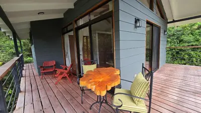 a patio with a table and chairs on a porch at Monteverde Casa Mia, near main attractions and town! in Monteverde Costa Rica