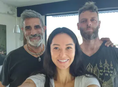 two men and a woman posing for a picture at Salamandra Room in Escazu