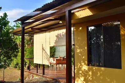 a pergola on a house with a deck at Dreamcatcher house in Sarchí