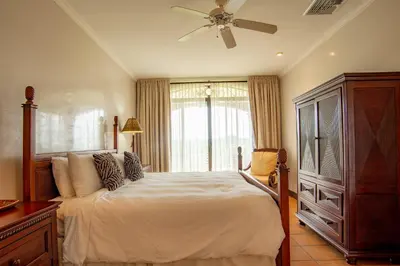 a bedroom with a bed and a ceiling fan at Elegant 3BR Condo - Bougainvillea - Reserva Conchal Golf Resort in Playa Conchal