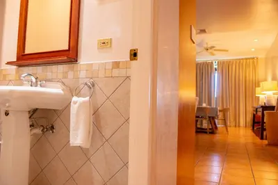 a bathroom with a sink and a mirror at Elegant 3BR Condo - Bougainvillea - Reserva Conchal Golf Resort in Playa Conchal