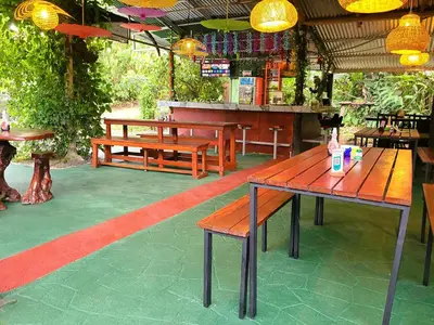 a patio with benches and tables in a restaurant at Chalets Silencio del Bosque in Fortuna