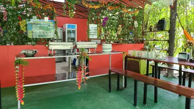 a restaurant with tables and flowers on the wall at Chalets Silencio del Bosque in Fortuna