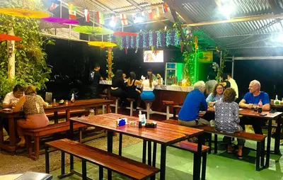a group of people sitting at tables in a restaurant at Chalets Silencio del Bosque in Fortuna