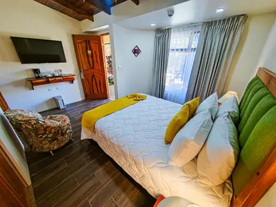 a hotel room with a bed and a television at Sibu Boutique Hotel in Monteverde Costa Rica