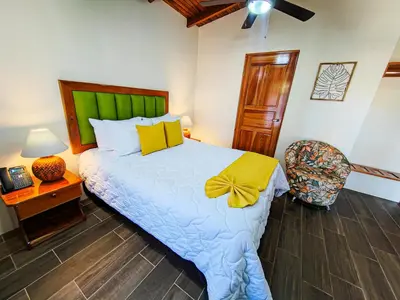 a bedroom with a bed with a yellow bow on it at Sibu Boutique Hotel in Monteverde Costa Rica