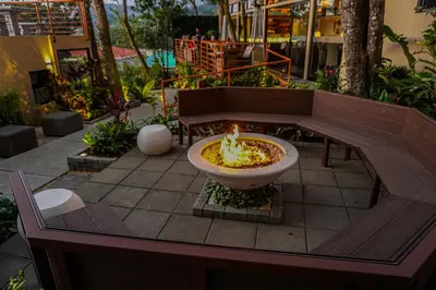 a park bench with a fountain in a courtyard at Sibu Boutique Hotel in Monteverde Costa Rica