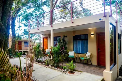 a house with a balcony with trees and plants at Sibu Boutique Hotel in Monteverde Costa Rica