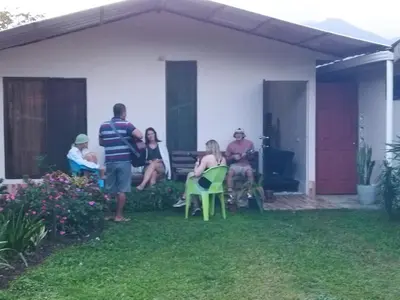 a group of people sitting outside of a house at Bijagua paradise Río Celeste in Bijagua