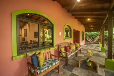 a porch with benches with pillows on it at 