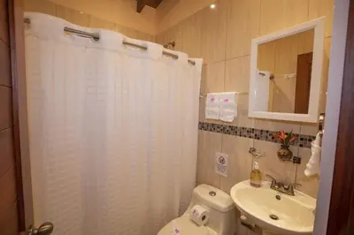 a bathroom with a white shower curtain and a sink at 