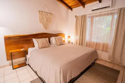 a bedroom with a large bed and a window at Curiol Boutique Hotel & Lounge in Potrero