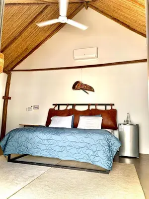 a bedroom with a bed with a ceiling fan at Curiol Boutique Hotel & Lounge in Potrero
