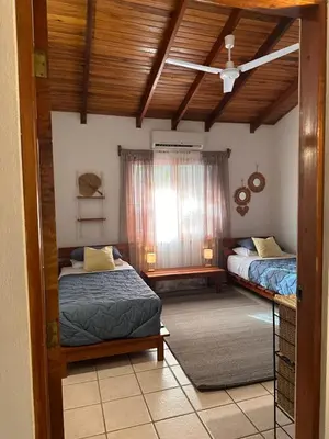 a bedroom with two beds and a ceiling at Curiol Boutique Hotel & Lounge in Potrero