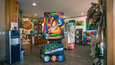 a room with colorful paintings on the walls at La Fortuna Downtown Boutique Hotel in Fortuna