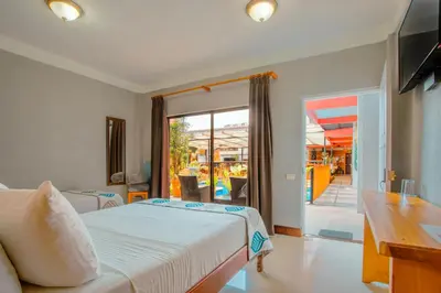 a bedroom with a bed and a sliding glass door at La Fortuna Downtown Boutique Hotel in Fortuna