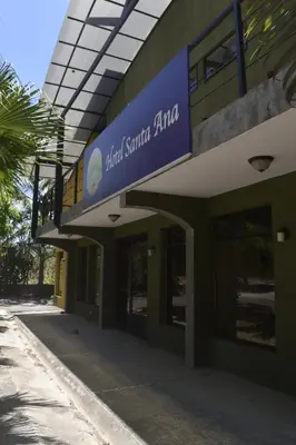 a building with a sign on the side of it at Hotel Santa Ana Liberia Airport in Liberia