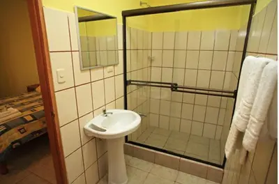 a bathroom with a sink and a shower at Hotel Santa Ana Liberia Airport in Liberia