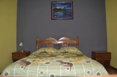 a bedroom with a bed and a picture on the wall at Hotel Santa Ana Liberia Airport in Liberia