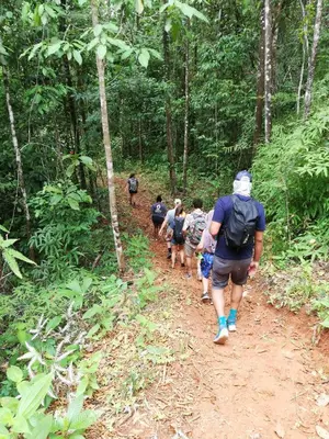 a group of people walking down a dirt trail in the woods at Hacienda Mil Bellezas - Private 40ha Jungle Reserve in Quepos