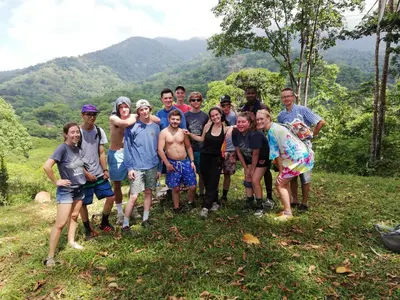 a group of people posing for a picture on a mountain at Hacienda Mil Bellezas - Private 40ha Jungle Reserve in Quepos