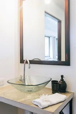 a bathroom sink with a glass bowl on a counter at Hacienda Mil Bellezas - Private 40ha Jungle Reserve in Quepos