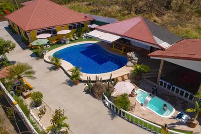 an aerial view of a house with a swimming pool at Hotel Boutique Meraki in Caldera