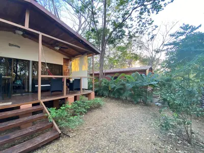 a house with a porch and a swing at CASA NATURaL in Brasilito